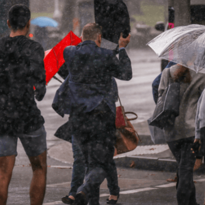 Pedestrians crossing the road in heavy rain